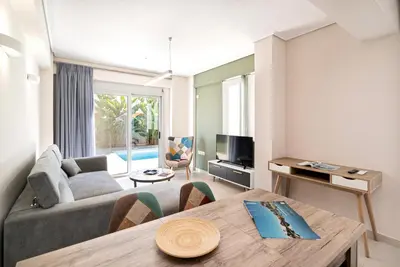 a living room with a couch and a table at Porto Rafti Dream Complex & Retreat in Porto Rafti