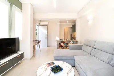 a living room with a couch and a tv at Porto Rafti Dream Complex & Retreat in Porto Rafti
