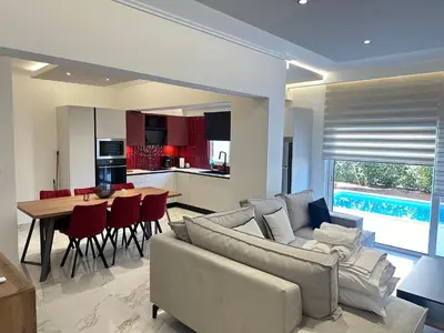 a living room and kitchen with a couch and a table at Porto Rafti Dream Complex & Retreat in Porto Rafti