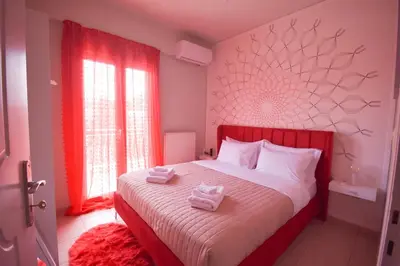 a bedroom with a bed with two towels on it at K&C Rooms- Apartments in Markopoulo