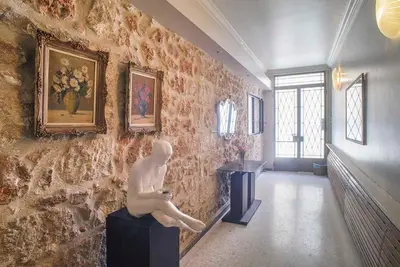 a statue of a man sitting on a wall at Little gem in the historical center of Athens in Athens