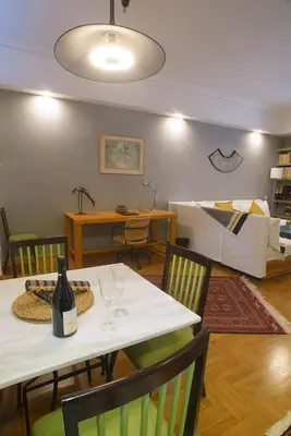 a room with a table and chairs with a bed at Little gem in the historical center of Athens in Athens