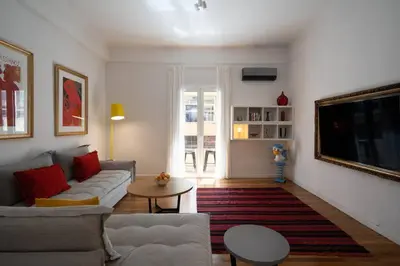 a living room with a couch and a table at Ebullience - Stylish & Chic Athens Apartment in Athens