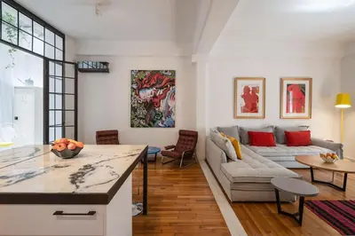 a living room with a couch and a table at Ebullience - Stylish & Chic Athens Apartment in Athens