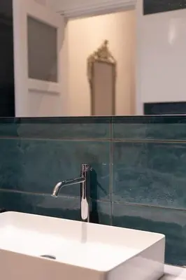 a bathroom with a white sink and a mirror at Ebullience - Stylish & Chic Athens Apartment in Athens