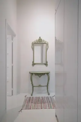 a room with a mirror and a table with a rug at Ebullience - Stylish & Chic Athens Apartment in Athens