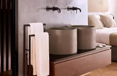 a bathroom with two large buckets on a table with towels at Cama Luxury Suites Kavouri in Athens