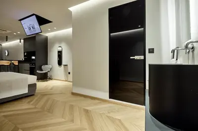 a bedroom with a bathroom with a sink and a mirror at Cama Luxury Suites Kavouri in Athens