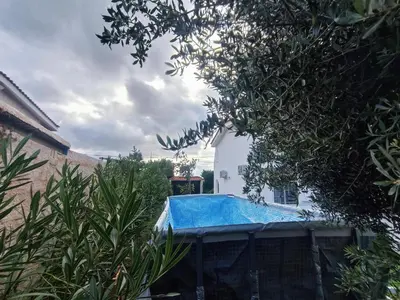 a swimming pool in the backyard of a house at New Olivka House in Anavissos