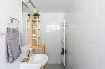 a white bathroom with a sink and a toilet at New Olivka House in Anavissos