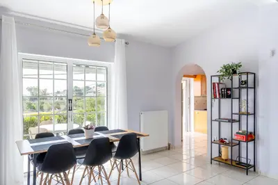 a dining room with a table and chairs at New Olivka House in Anavissos