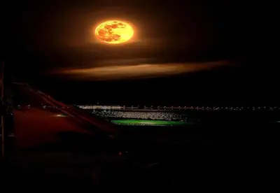 a full moon rising over the ocean at night at New Olivka House in Anavissos