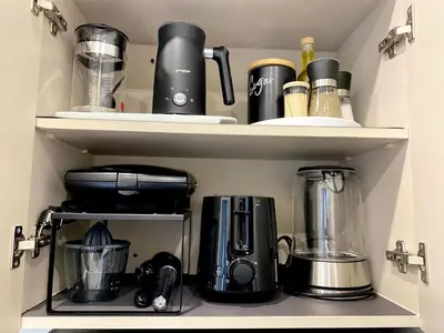 a cupboard filled with lots of kitchen items at Sand by Aestas Suites in Artemida