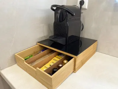 a wooden drawers with a black counter top and a mortar at Sand by Aestas Suites in Artemida