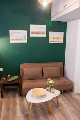 a living room with a couch and a table at Melina’s Flat in Athens
