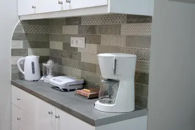 a kitchen counter with several appliances on it at Melina’s Flat in Athens